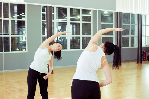 Güzel genç bir spor salonunda egzersiz yaparak — Stok fotoğraf