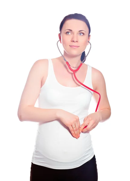 Pregnant woman listening to baby — Stock Photo, Image