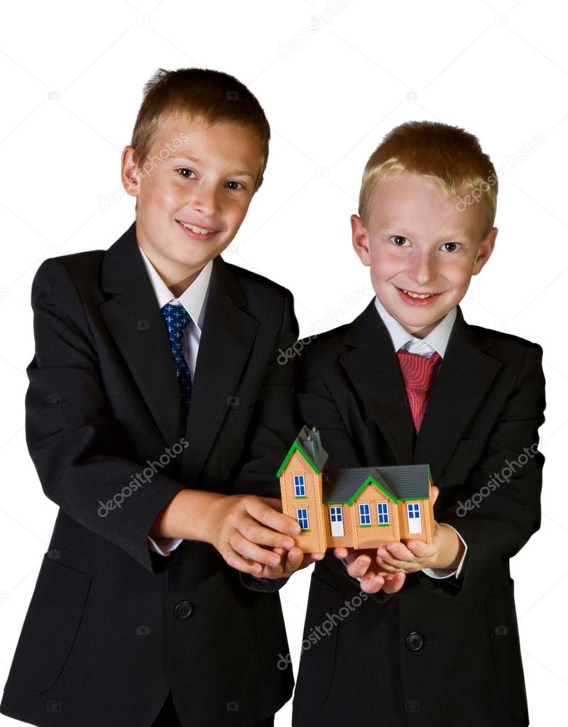 two boys holding toy house, isolated on white
