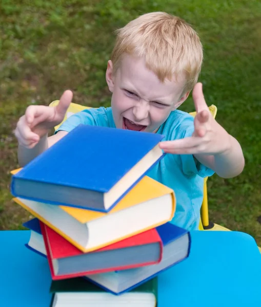 Angry boy doesn't like reading — Stock Photo, Image