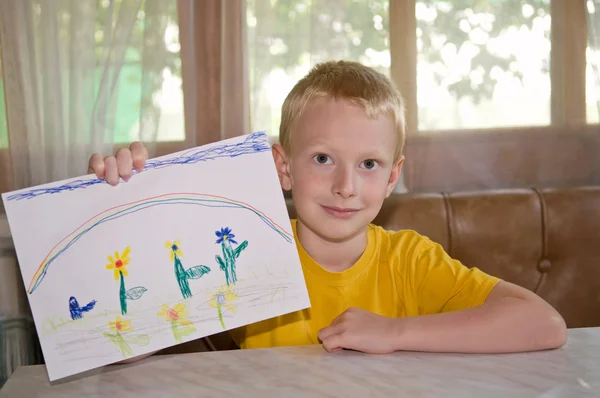 Smiling boy showing his picture — Stock Photo, Image