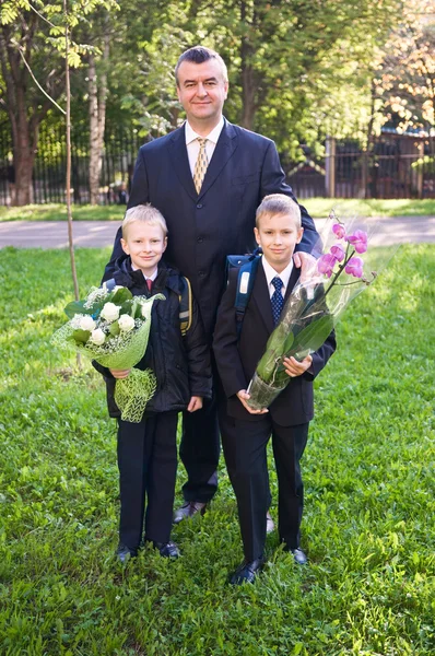 Schoolboys and father — Stock Photo, Image