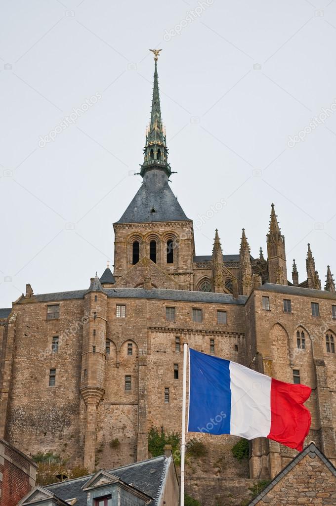 French flag in front of Mont Saint-Michel.