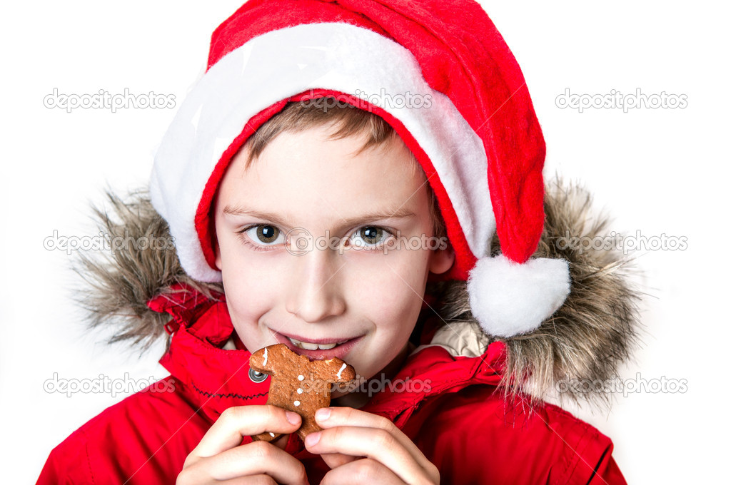 Boy eating gingerbread man.