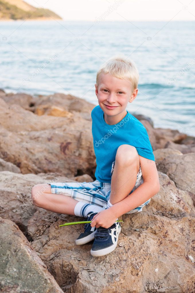 Portrait of young smiling boy at the sea