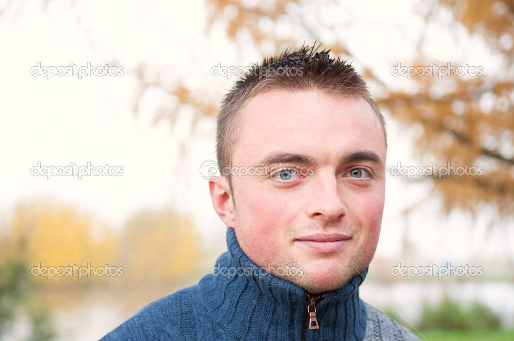 Portrait of young man in autumn park