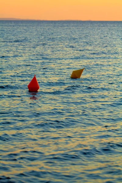 Red and yellow buoys during sunset — Stock Photo, Image