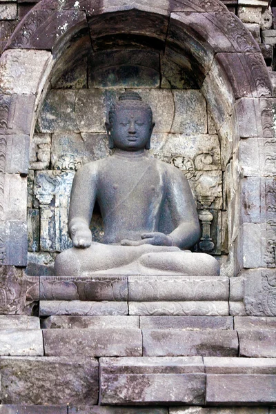 One of 504 Buddha statues of Borobudur Buddhist temple (IX cent.), UNESCO World Heritage Site, Magelang, Java, Indonesia — Stock Photo, Image