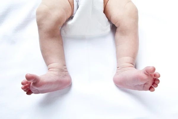 Newborn baby feet over white background — Stock Photo, Image