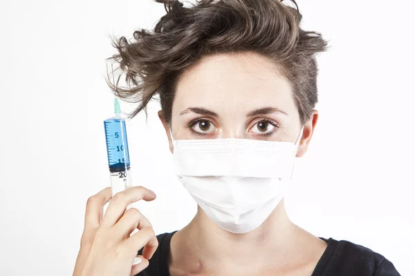 Young pretty nurse in mask with syringe — Stock Photo, Image