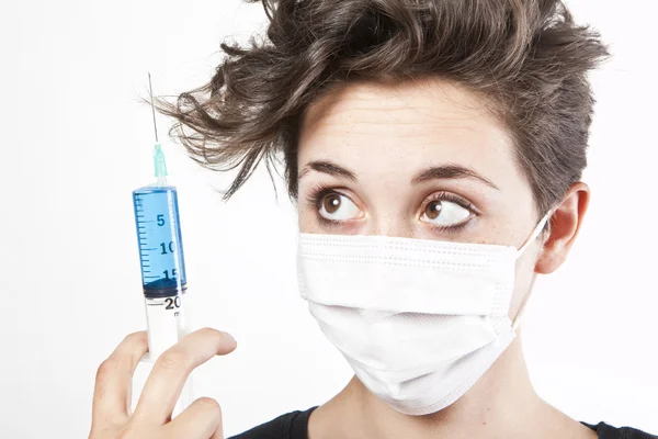 Young pretty nurse in mask with syringe — Stock Photo, Image