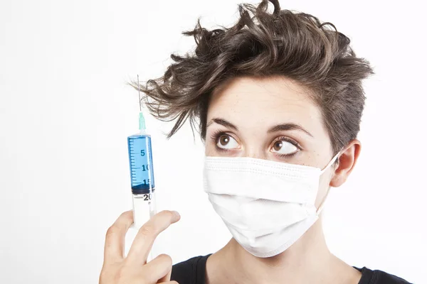 Young pretty nurse in mask with syringe — Stock Photo, Image