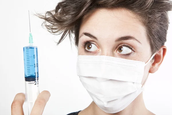 Young pretty nurse in mask with syringe — Stock Photo, Image