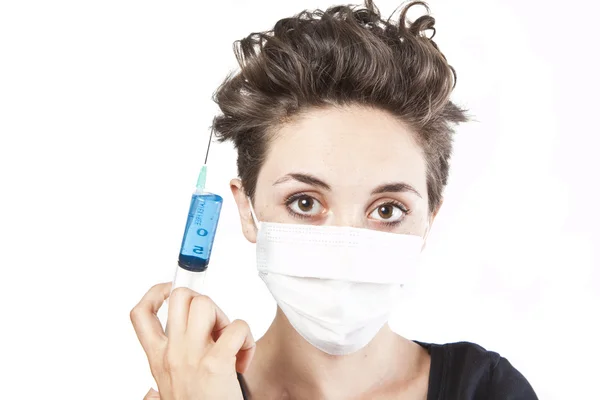 Young pretty nurse in mask with syringe — Stock Photo, Image