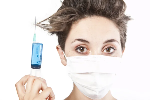 Young pretty nurse in mask with syringe — Stock Photo, Image