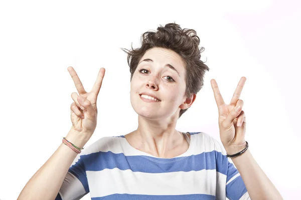 Beautiful young girl making a victory sign isolated over white background — Stock Photo, Image