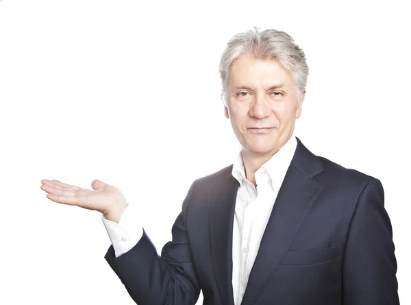 Happy senior businessman with hand gesture showing copyspace on white background — Stock Photo, Image