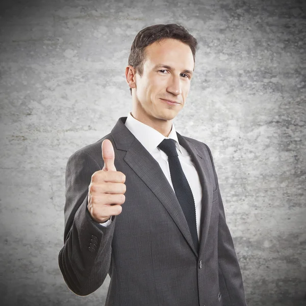 Smiling businessman with thumb up — Stock Photo, Image