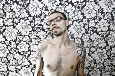 skinny tattoo guy on floral background