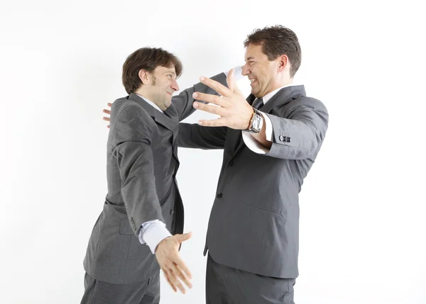 Dos hombres de negocios felices viéndose aislados en blanco — Foto de Stock