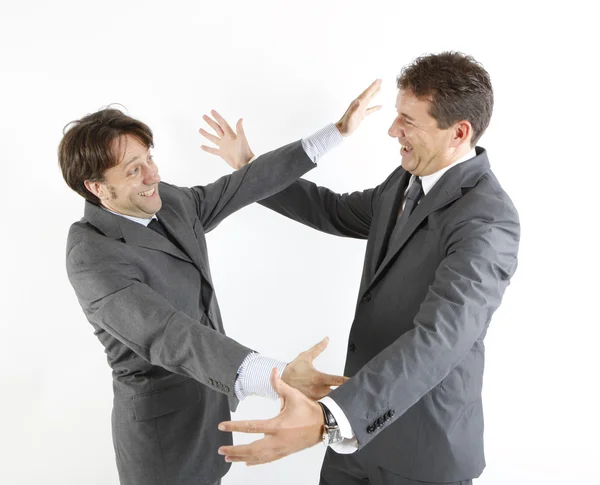 Dos hombres de negocios felices viéndose aislados en blanco — Foto de Stock