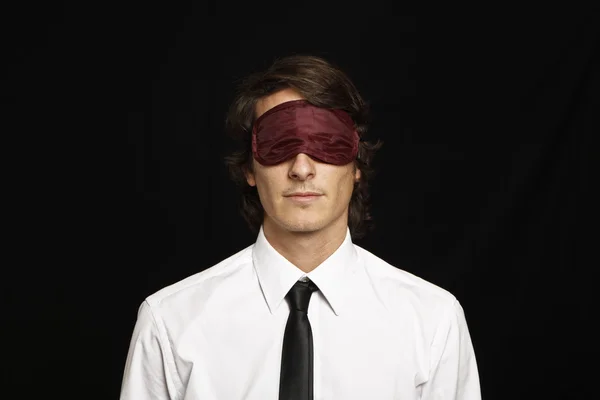 Young businessman with eyes covered by sleep mask — Stock Photo, Image