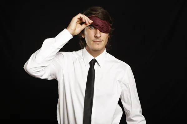 Young businessman looking below sleep mask — Stock Photo, Image