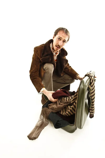 Funny vintage young man looking in his suitcase — Stock Photo, Image