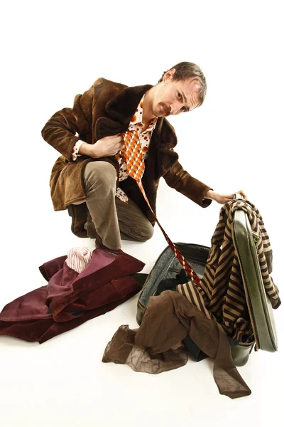 Funny vintage young man looking in his suitcase — Stock Photo, Image