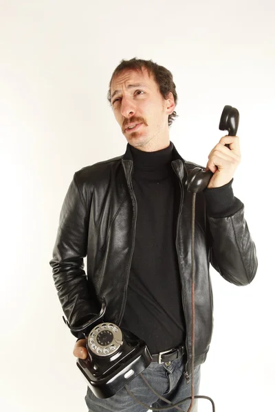 Young handsome guy with black telephone — Stock Photo, Image