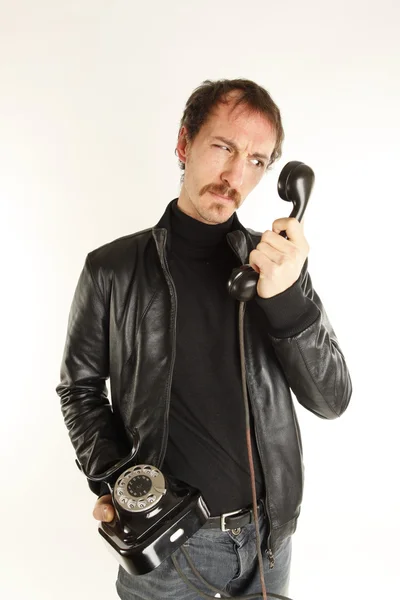 Young handsome guy with black telephone — Stock Photo, Image