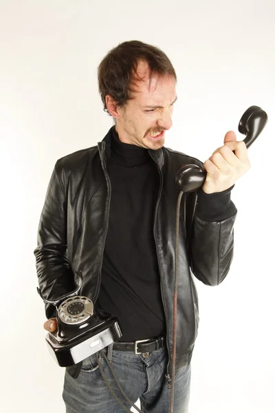 Young handsome guy with black telephone — Stock Photo, Image