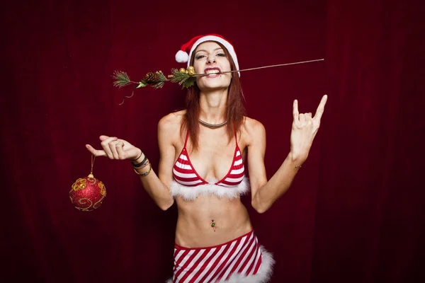 Rock style christmas girl over red background — Stock Photo, Image