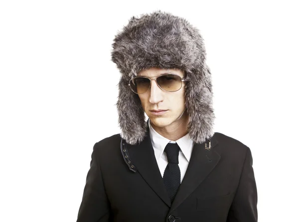 Attractive young man wearing elegant black suit,sunglasses and russian hat — Stock Photo, Image