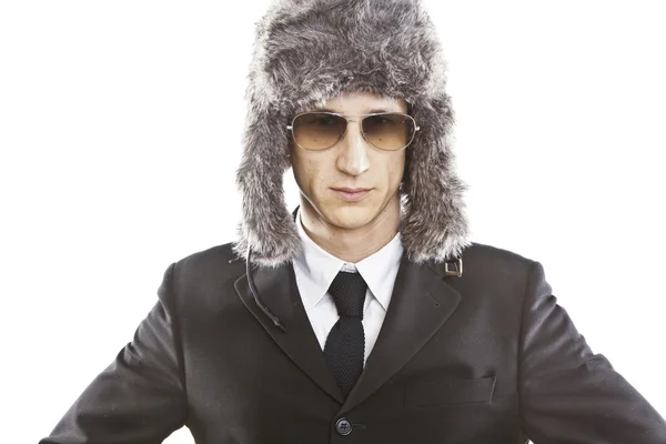 Attractive young man wearing elegant black suit,sunglasses and russian hat — Stock Photo, Image