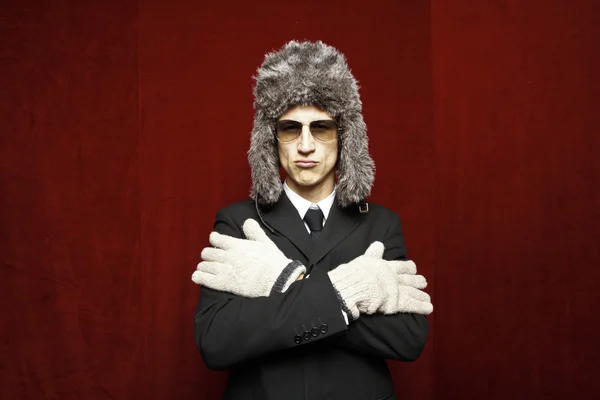 Attractive young man wearing elegant black suit,sunglasses and russian hat — Stock Photo, Image