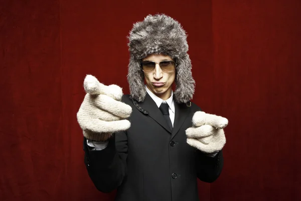 Attractive young man wearing elegant black suit,sunglasses and russian hat — Stock Photo, Image