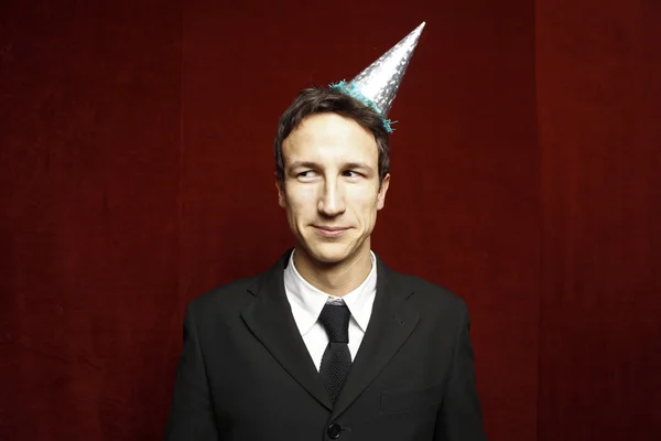 Funny businessman with party hat — Stock Photo, Image