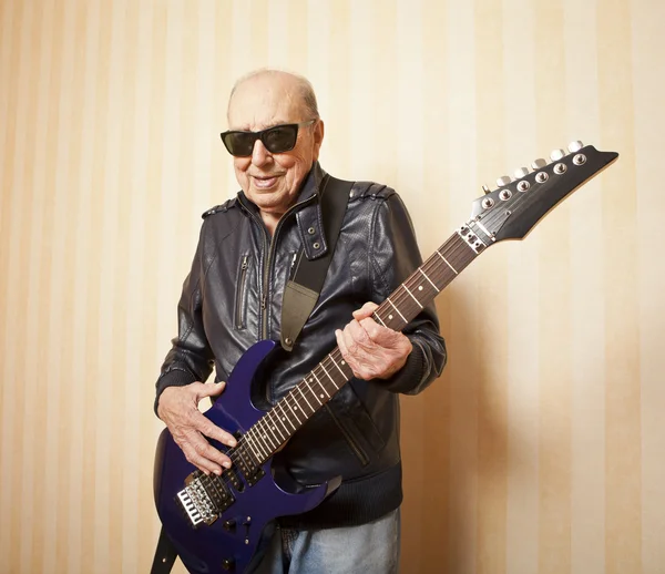 cool fashion elder man with electric guitar