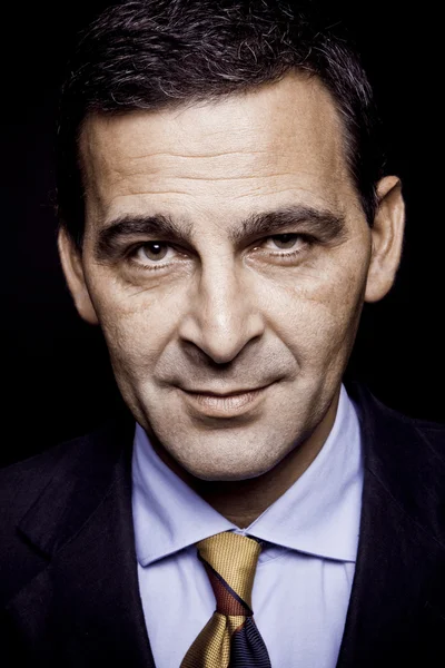 Portrait of confident businessman over black background — Stock Photo, Image