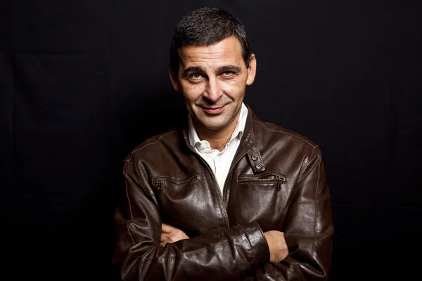 Portrait of a cool mature man with leather jacket over black bac — Stock Photo, Image