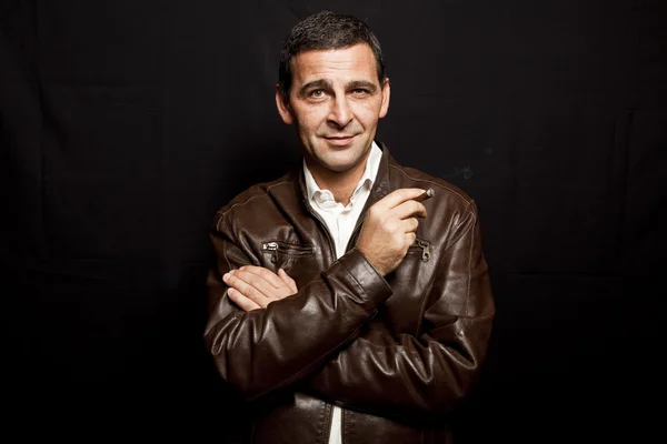 Portrait of a cool mature man with leather jacket over black bac — Stock Photo, Image