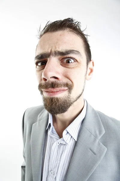 Crazy young businessman facial expressions — Stock Photo, Image