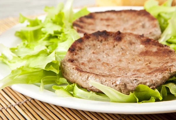 Two hamburger on green lettuce — Stock Photo, Image