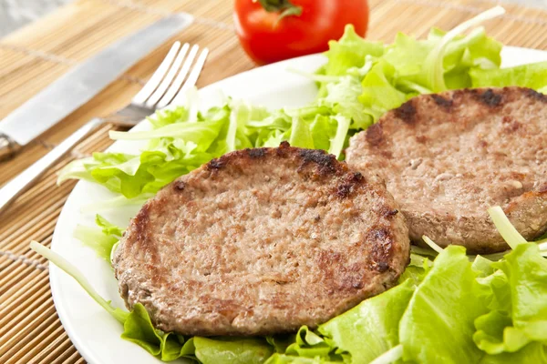 Two hamburger on green lettuce — Stock Photo, Image