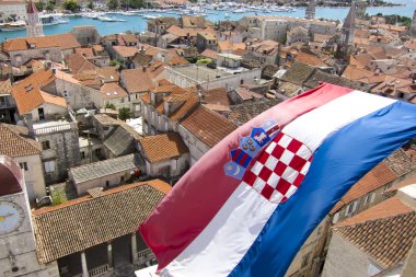 croatian flag on the city of trogir in dalmatia clipart