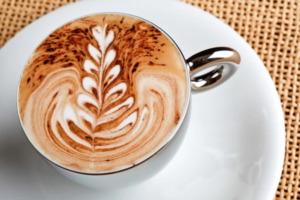 Art latte on a cappuccino coffe cup — Stock Photo, Image