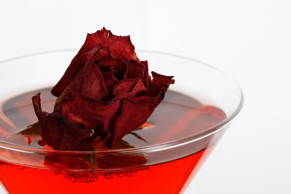 Rose floating in a red liquor — Stock Photo, Image