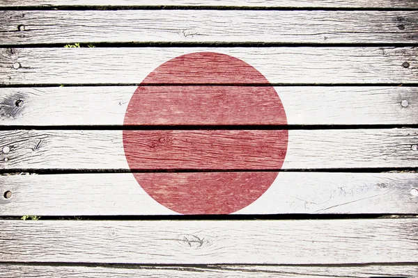 Япония, японский флаг, раскрашенный на старом деревянном фоне — стоковое фото