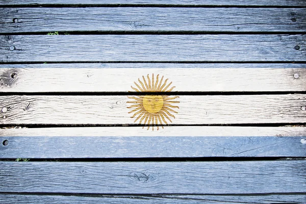 Argentina, bandera argentina pintada sobre fondo de madera vieja — Foto de Stock